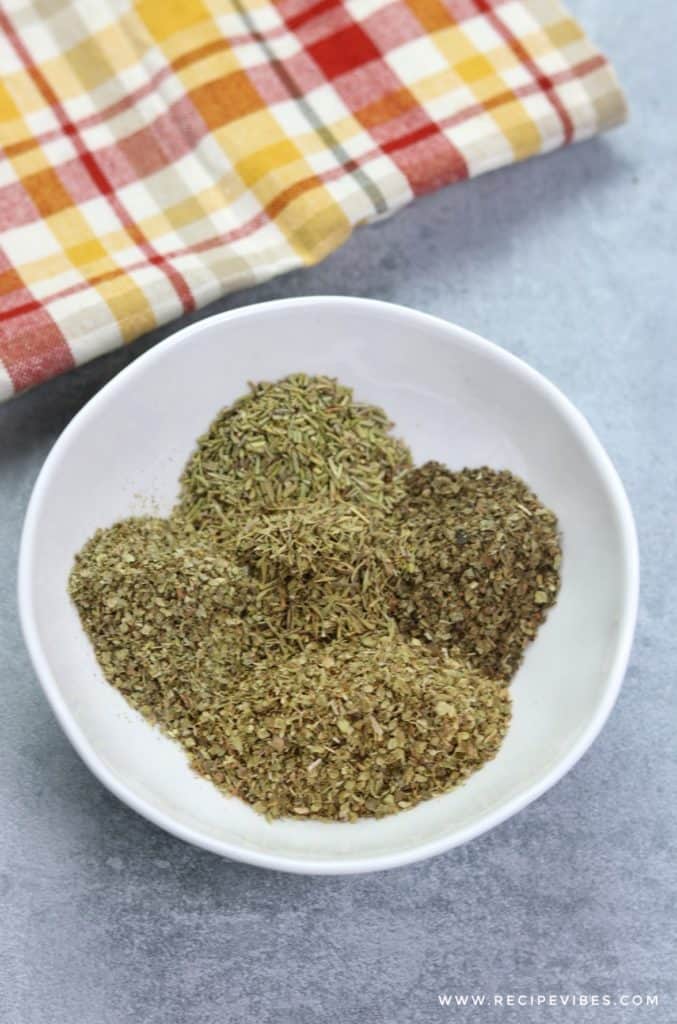 pour Italian seasoning herbs in a bowl