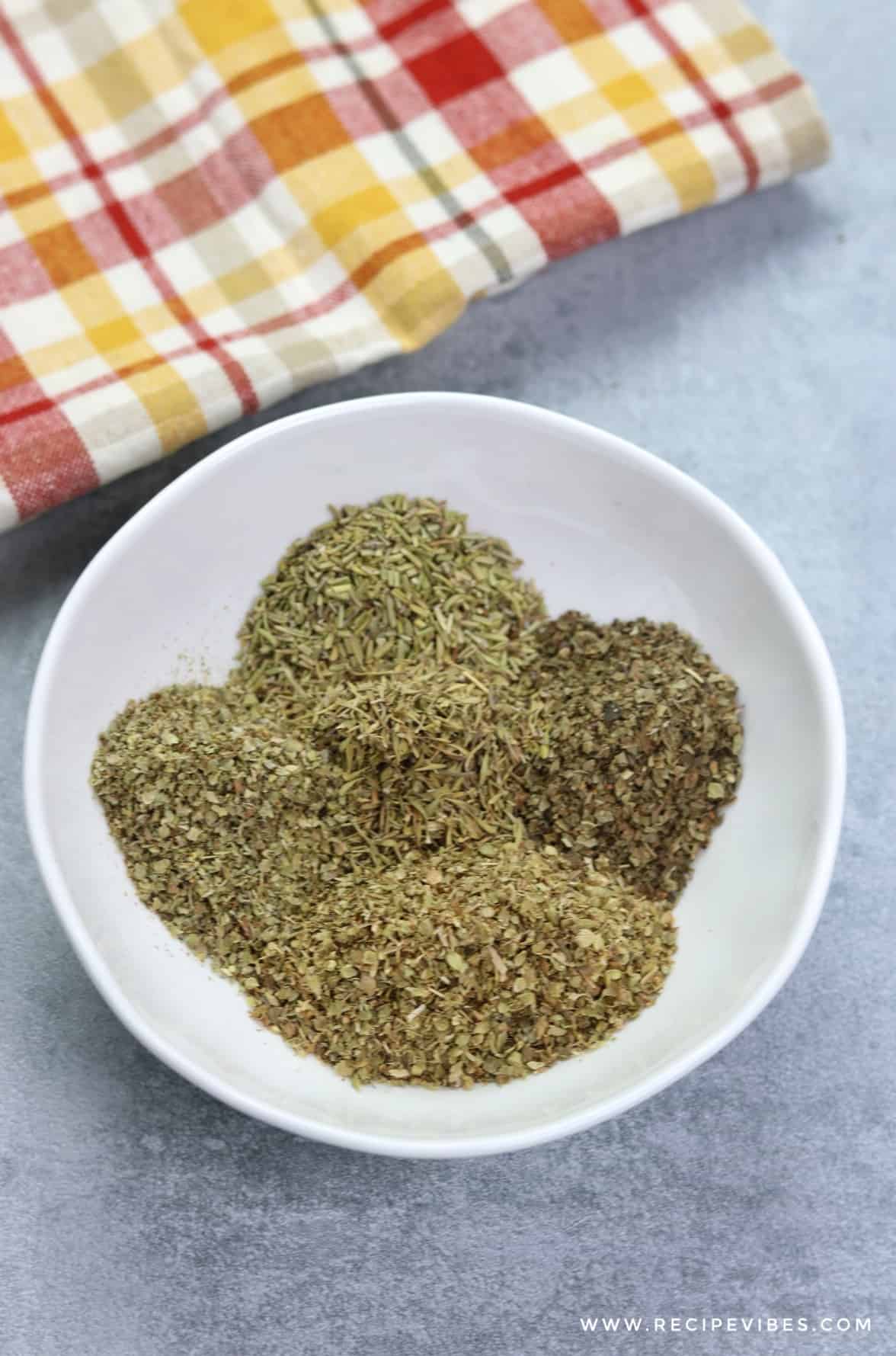 pour Italian seasoning herbs in a bowl