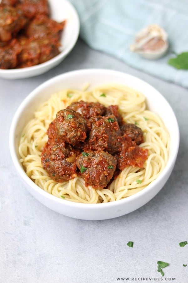 A plate of spaghetti topped with meatballs sauce
