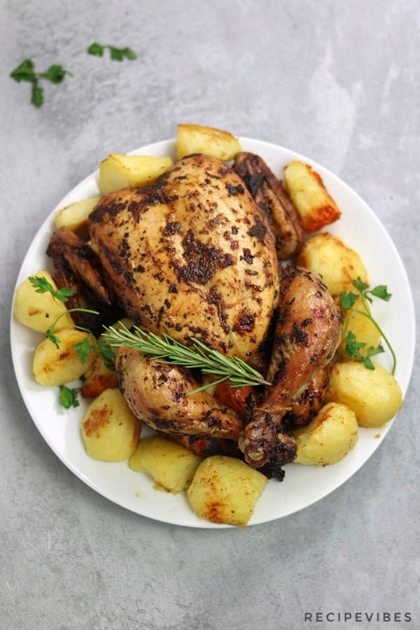 simple whole roast chicken served with roast potatoes