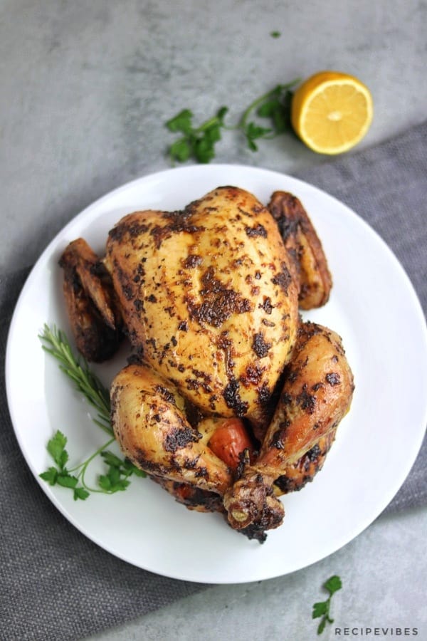simple whole roasted chicken served on white plate