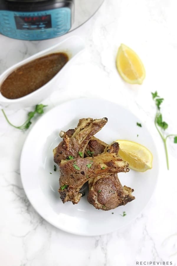 instant pot lamb chops served with gravy in a boat