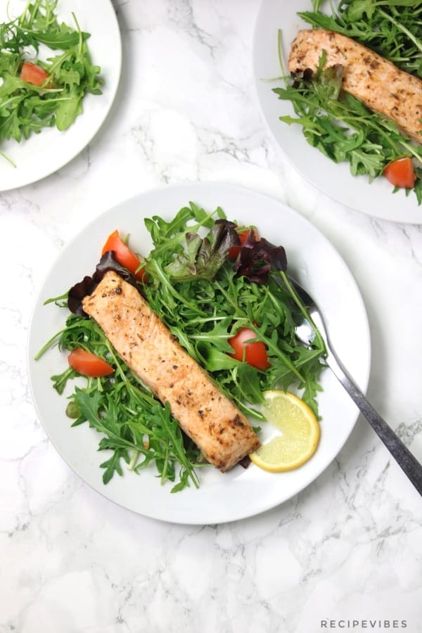 3 plates of Salmon on a bed of salad