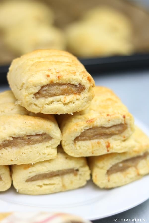 sausage rolls stacked on white plate