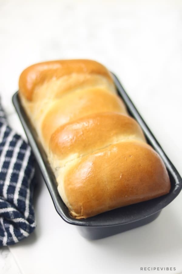 baked bread out of the oven and brushed with butter