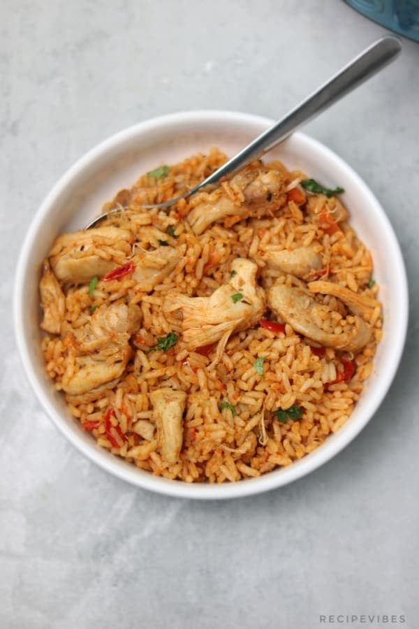 rice and chicken garnished with chopped coriander