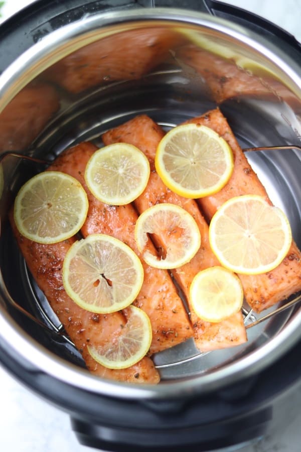 Salmon in instant pot with lemon slices on top