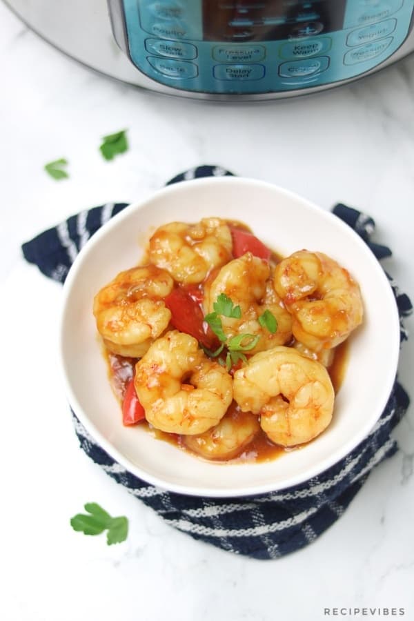 instant pot pressure cooker shrimp served in white bowl and garnished with spring onions