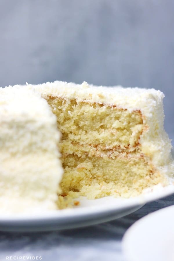 coconut cake with a cut out portion
