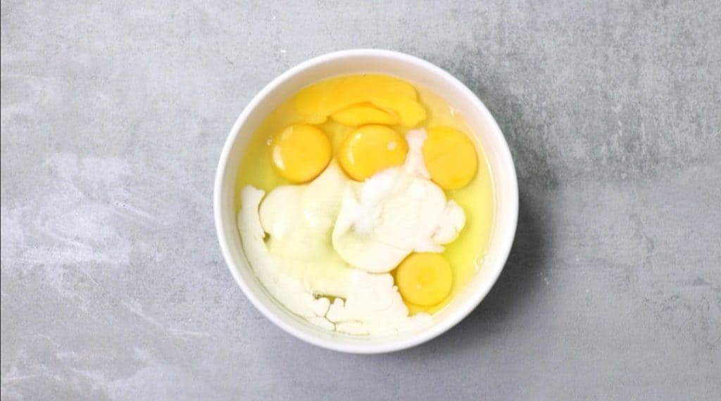 eggs, coconut milk and coconut extract in bowl