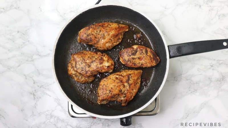 cooked chicken breasts in pan
