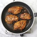 4 cooked chicken breasts in pan