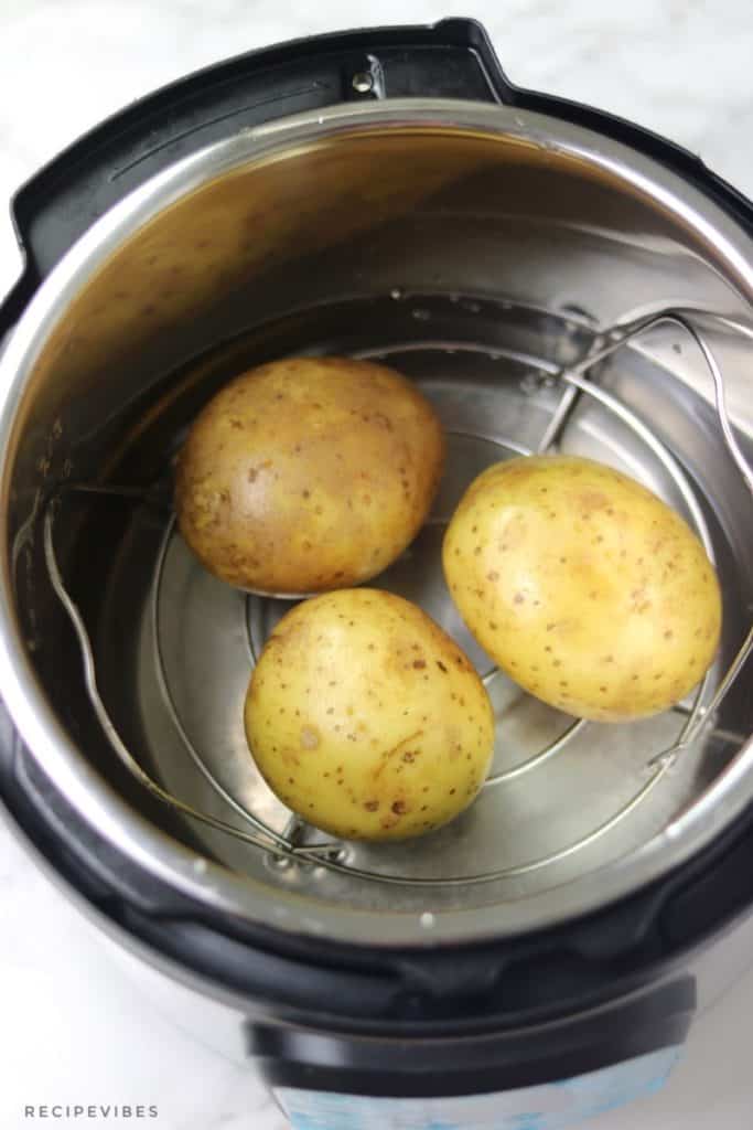 3 potatoes on trivet inside instant pot