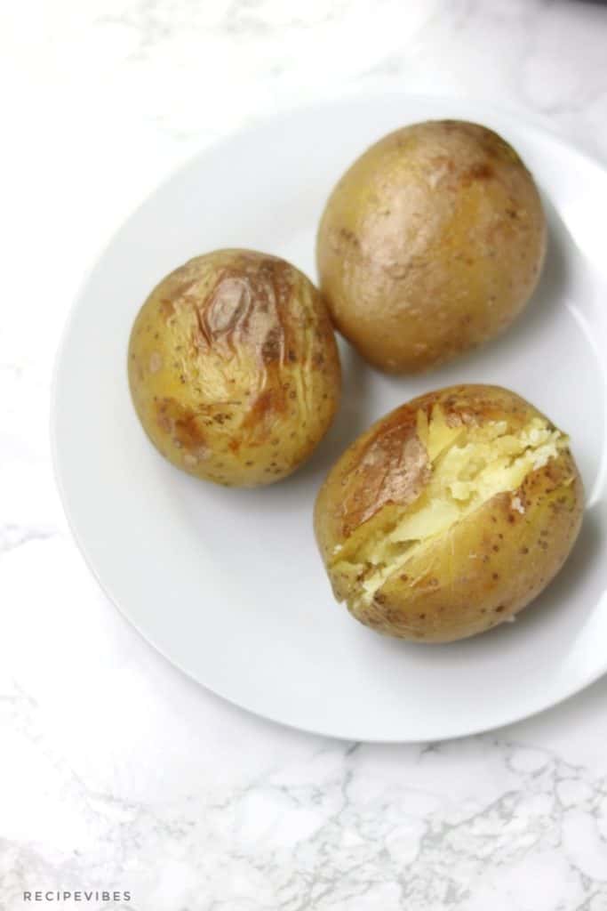 3 baked potatoes on white plate