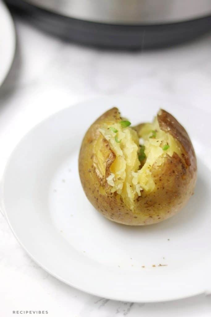 A baked potato displayed in front of instant pot