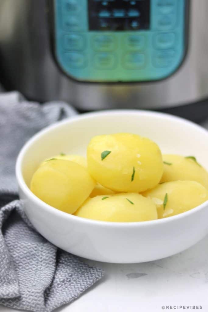boiled potatoes in plate placed infrom of instant pot