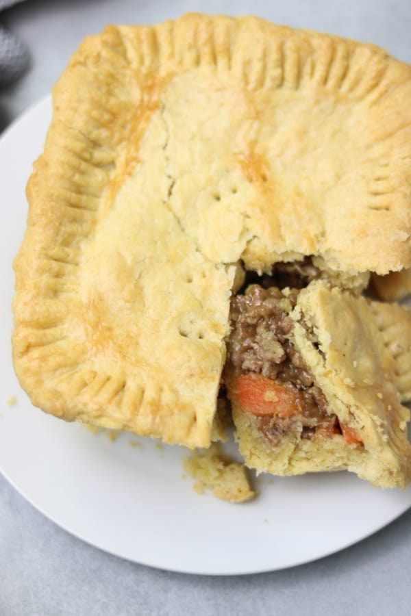 Meat pie served on white plate