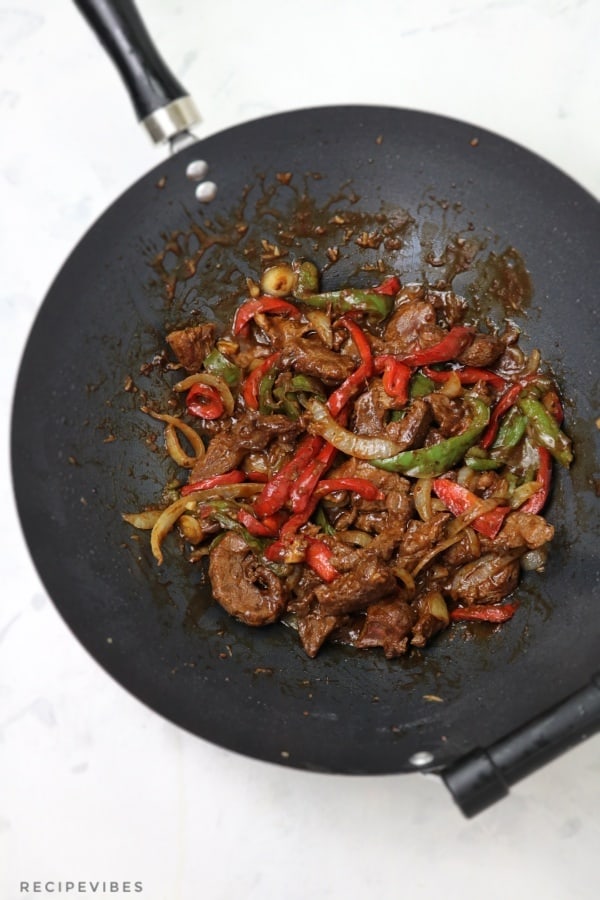 cooked pepper steak inside a wok