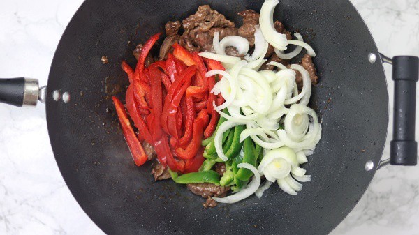 add bell peppers and onions in the wok