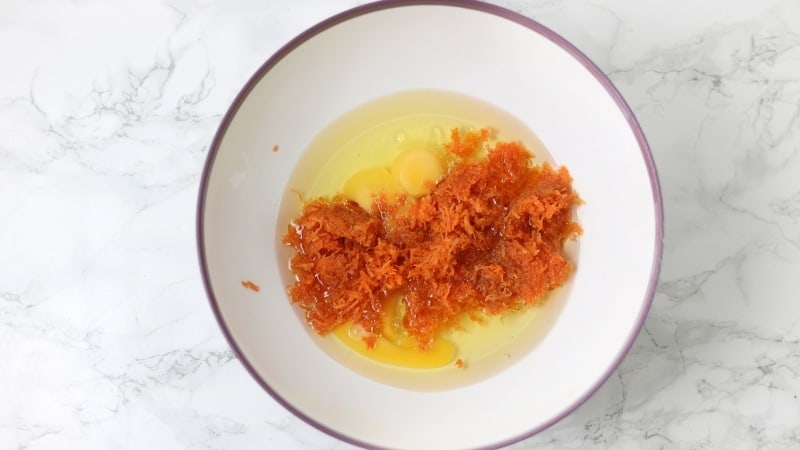 eggs, oil and grated carrot in mixing bowl