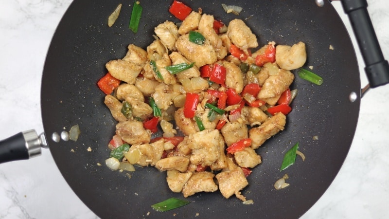 cooked salt and pepper chicken inside wok.