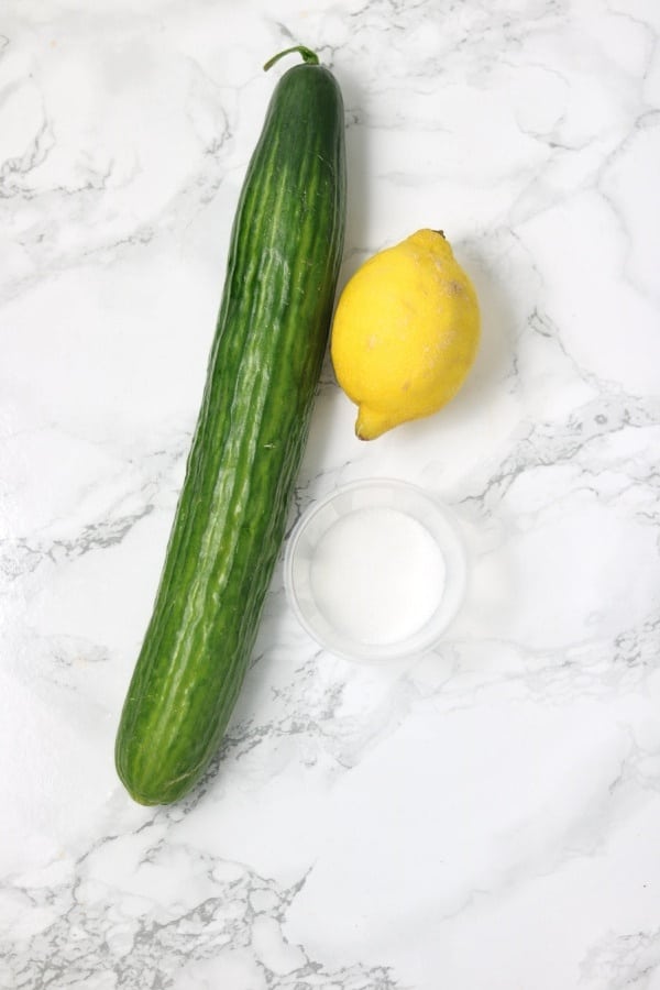 cucumber, lemon and sugar on white and grey background.