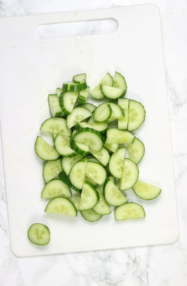 sliced cucumbers on chopping board