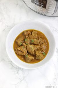 instant pot beef curry served in a white bowl