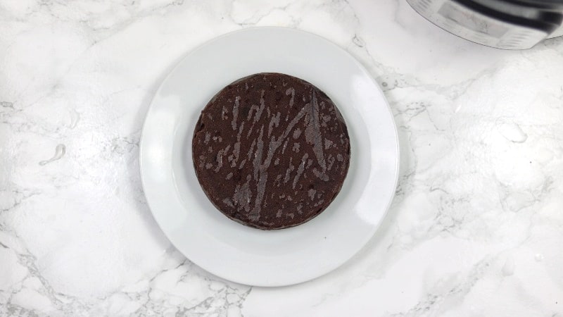 baked chocolate cake placed on a white plate.