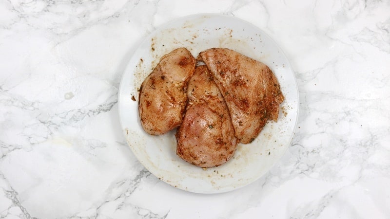 chicken breasts marinated with jerk seasoning and salt.