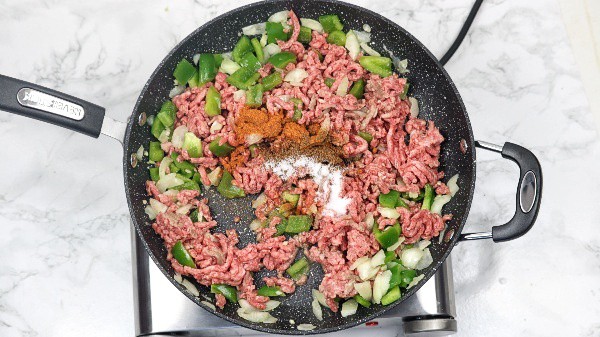 ground beef, chili, black pepper, boillon and salt added in the skillet.