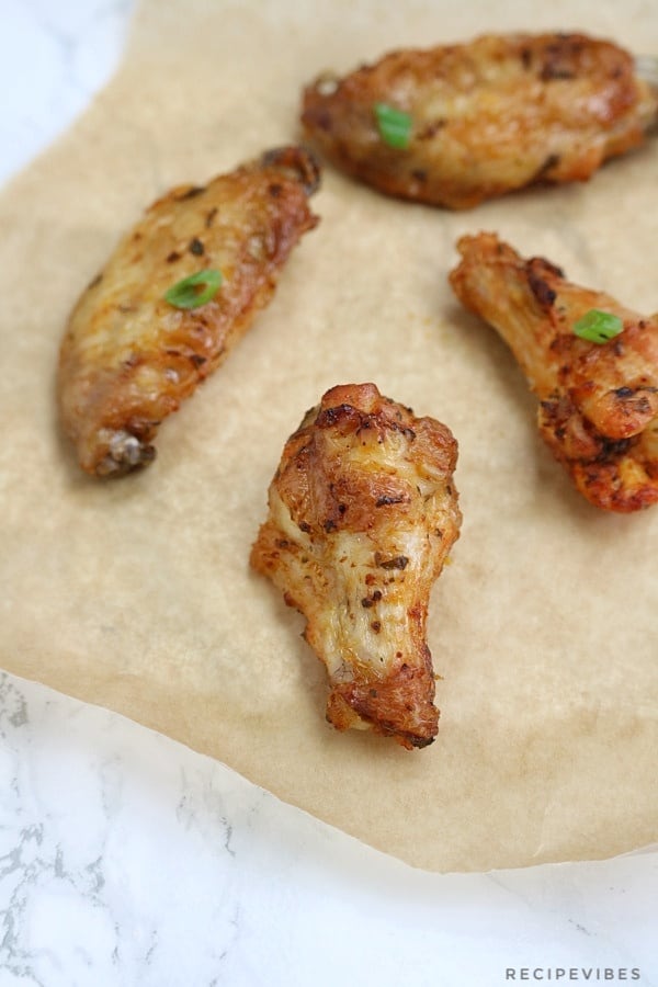 baked chicken wings on brown  parchment paper.