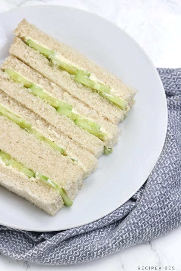 cucumber sandwiches on a white plate.