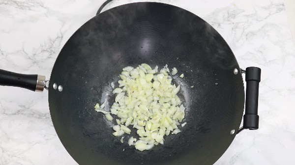 sauteed onions and garlic in a wok.