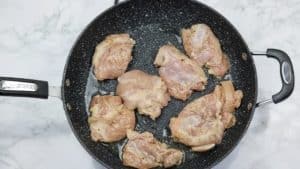 marinated chicken in a skillet.