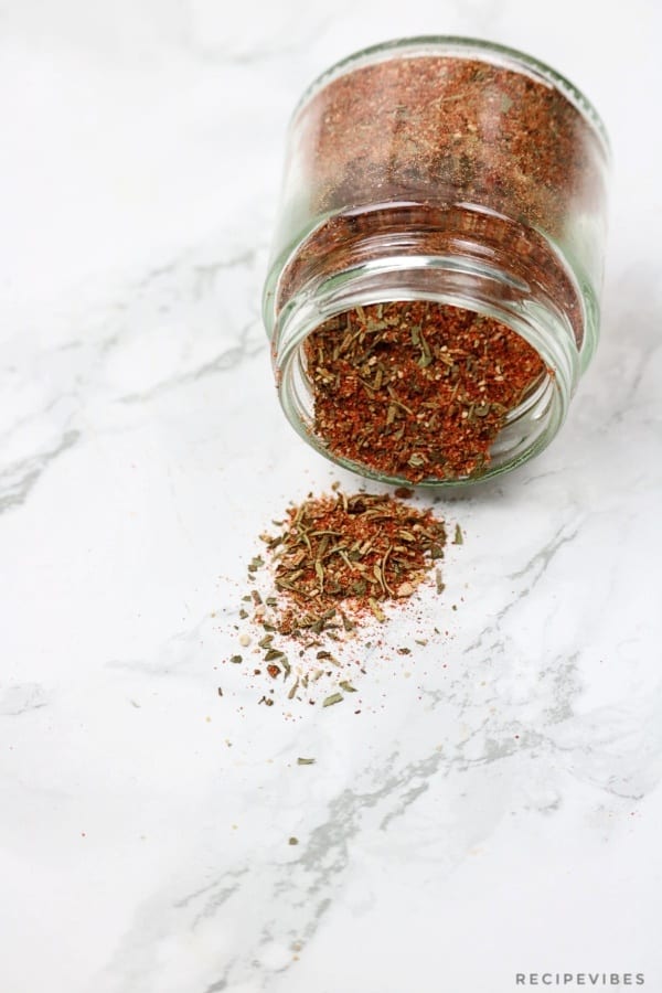 spice jar with a spill of the seasoning on the table.