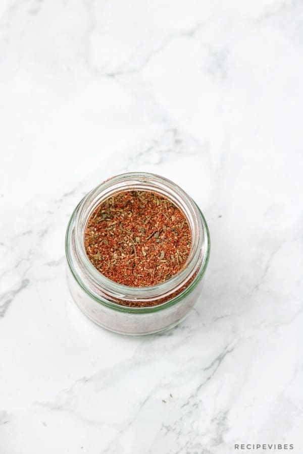 The freshly made chicken seasoning in a spice jar.