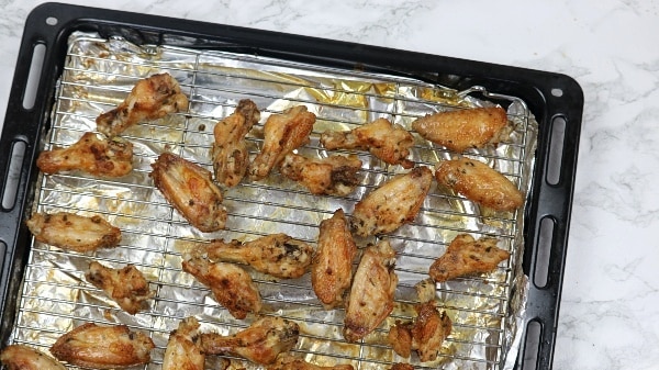 Baked wings on oven tray.