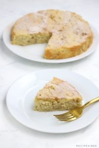 Apple cake with a slice cut out and placed on a plate.