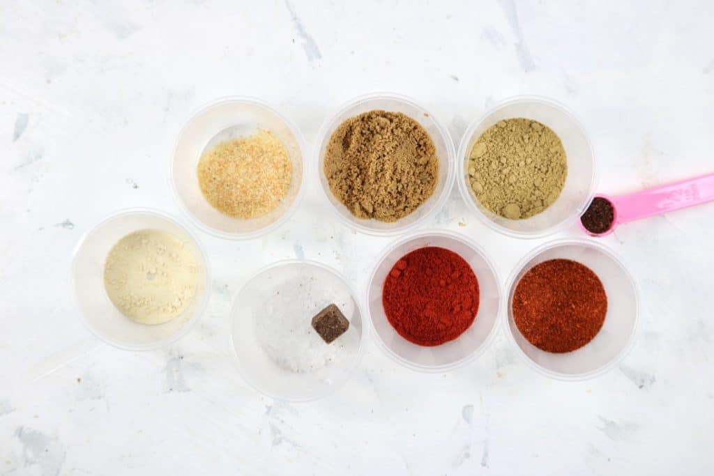 Suya spice ingredients set on a white table.