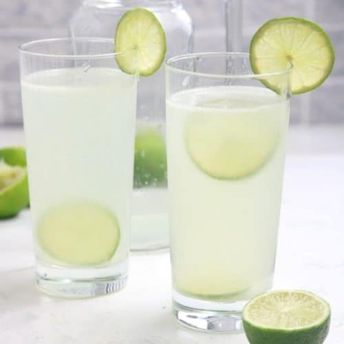 Limeade served in glasses and garnished with lime slices.