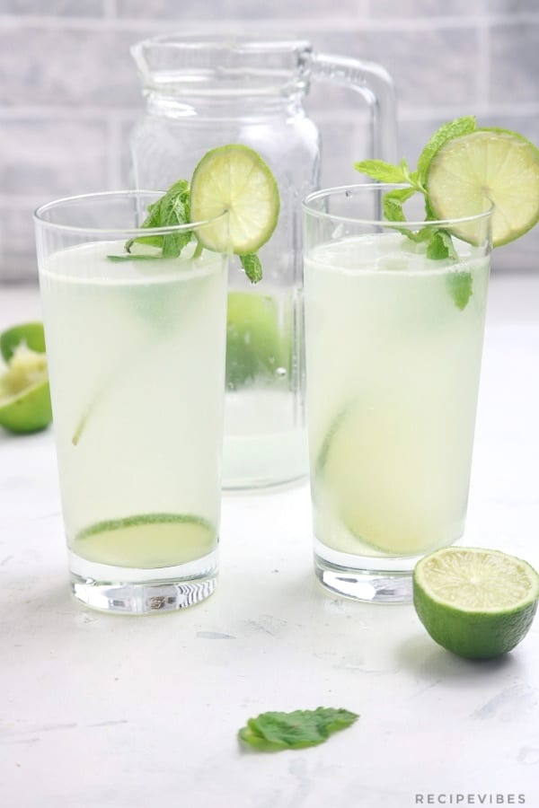 The drink garnished with mint leaves and lime slices.