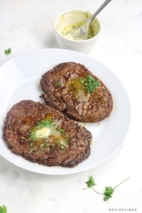 air fryer steak topped with garlic butter.