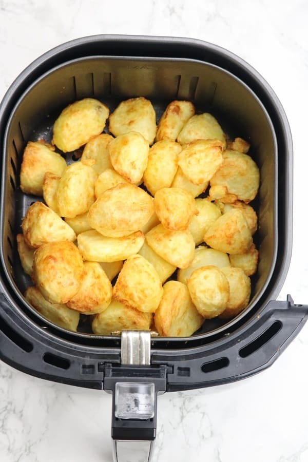 cooked dish in air fryer basket.