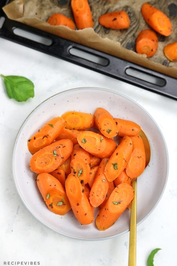 oven roasted carrots served in a light blue plate.