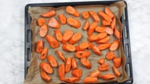carrots arranged in baking paper covered oven tray.