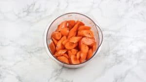 Diagonally cut carrots in a bowl.