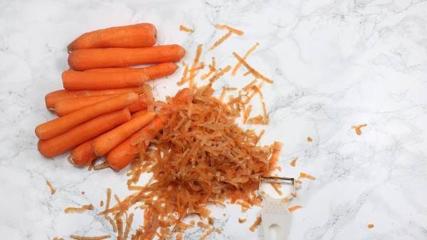 scraping skin off the carrots.