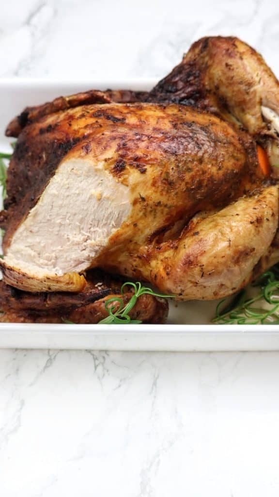 Whole Roast turkey with a slice cut off to show the inside.