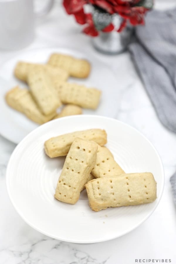shortbread cookies served on two white plates.